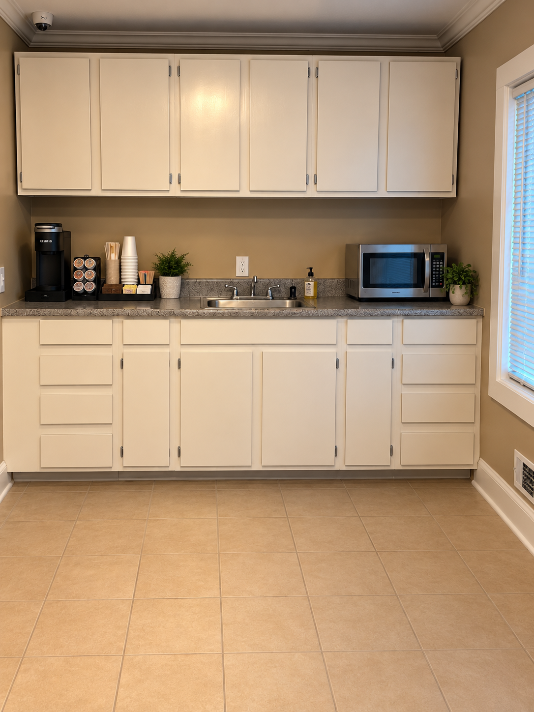 Kitchenette with coffee station, sink and microwave